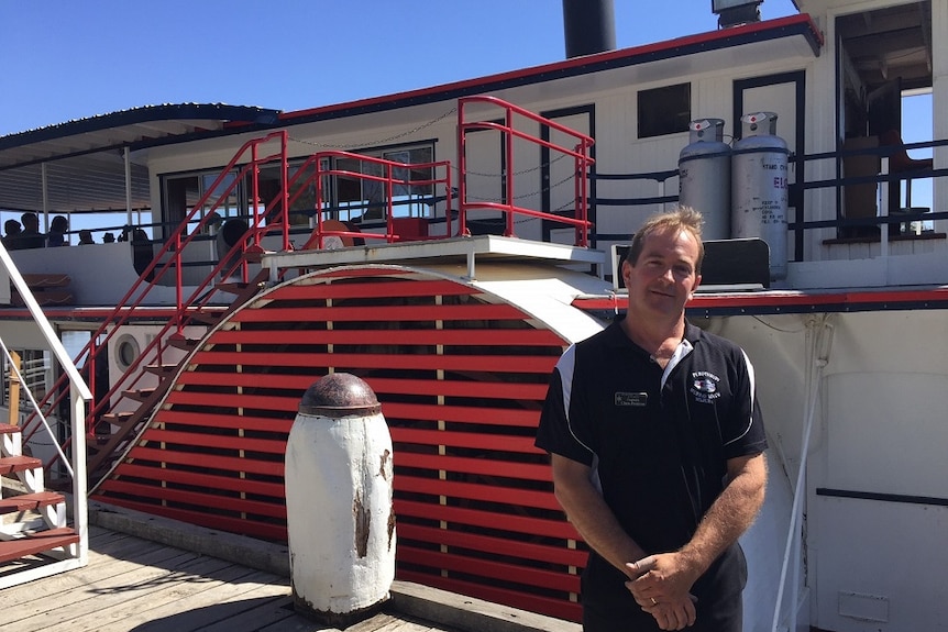 Chris Pointon stands in front of paddle-boat