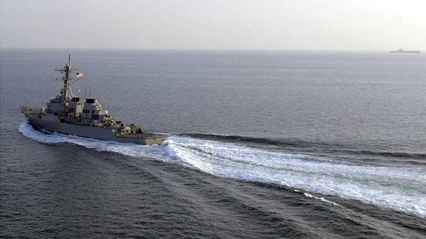 The USS Curtis Wilbur sailing on a clear ocean.