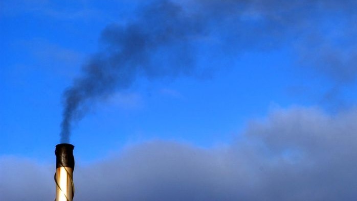 Smoke is emitted from a smoke stack