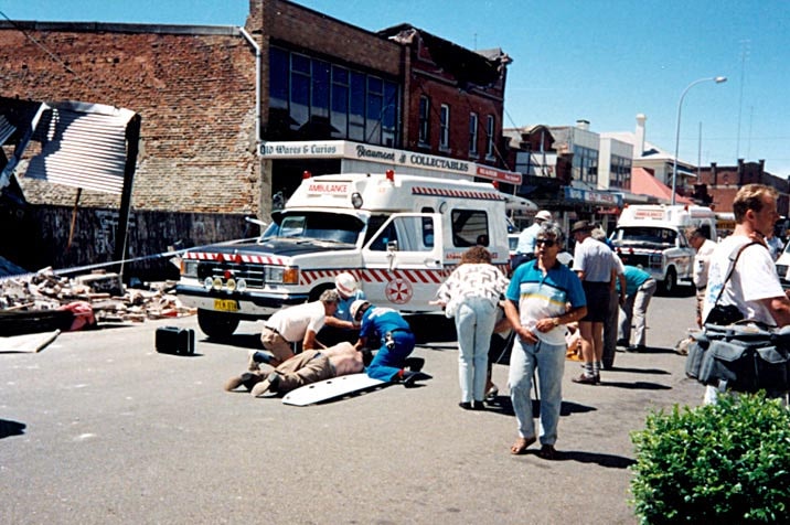 Ambulance officers and members of the public assist injured people in the street in Newcastle after the 1989 earthquake.