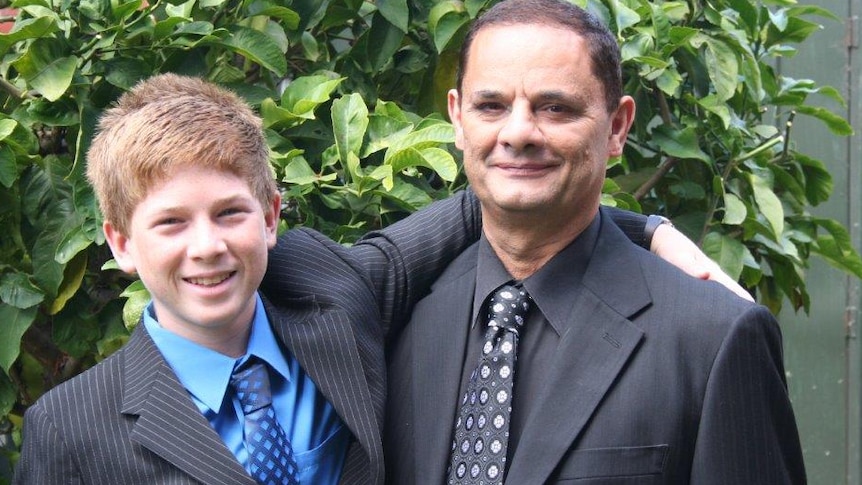 a young Kyle and Vince standing together in the garden