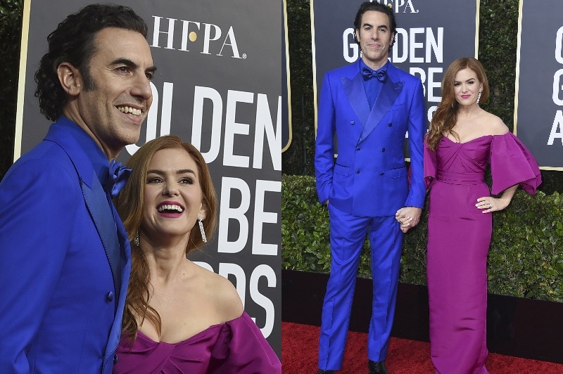 Sacha Baron Cohen wears a blue suit and Isla Fisher wears a fuchsia off the shoulder gown