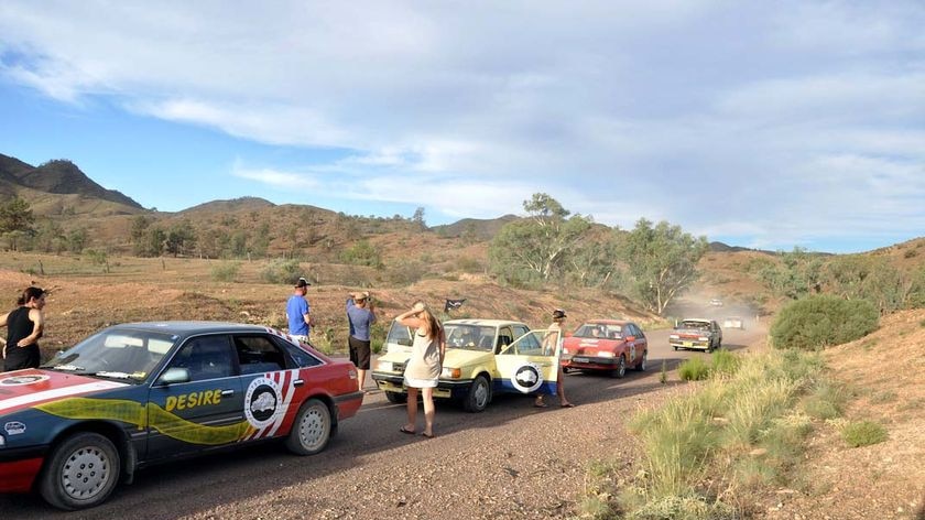 Competitors in the 'shitbox rally' stop in the outback