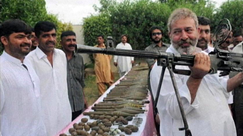 Chaudry Aslam Khan (holding gun), who was the head of anti-terror operations in Karachi, Pakistan.