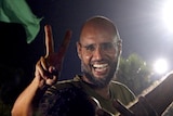 Saif al-Islam all smiles as he appears in his father's residential complex