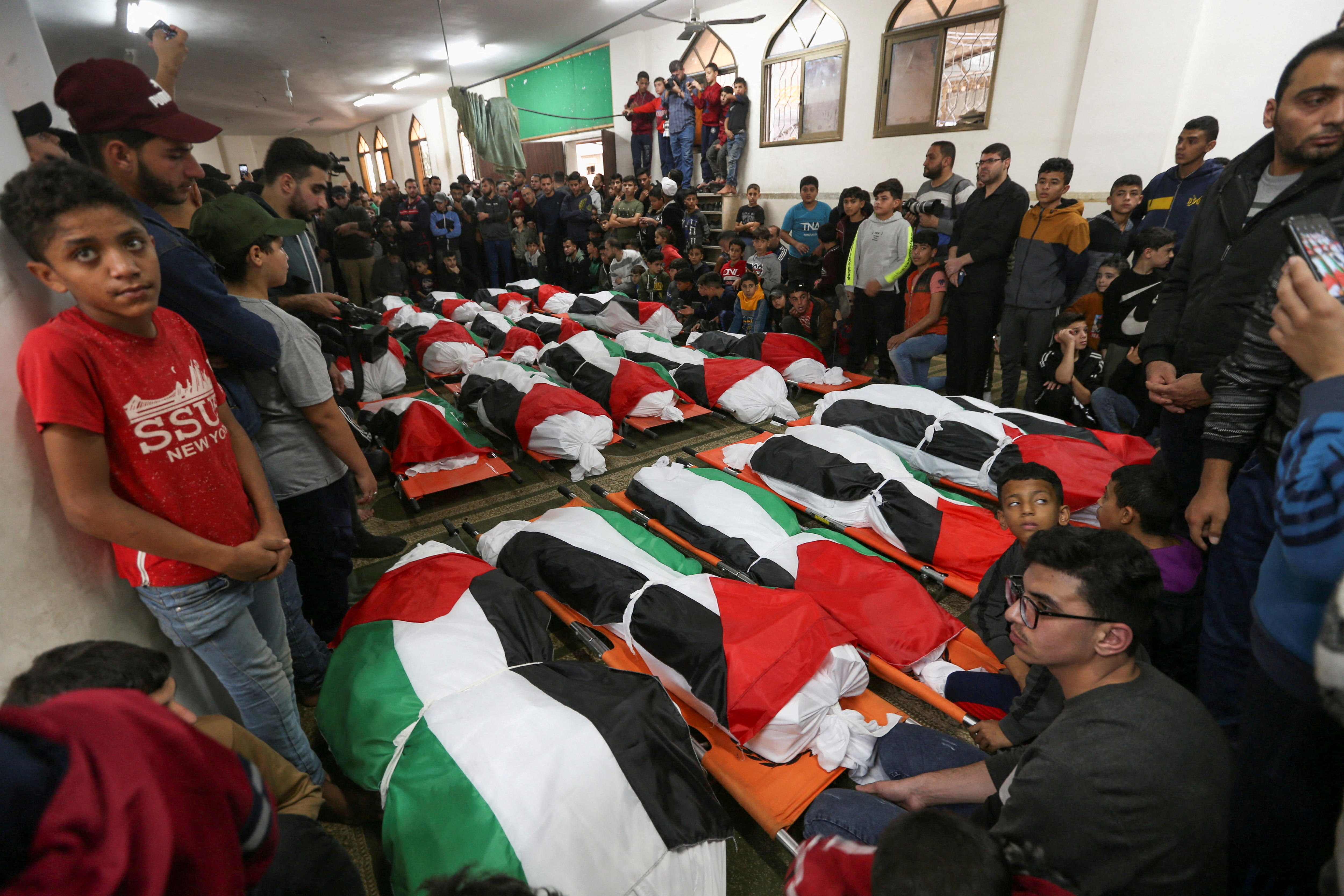 Palestinians flood streets of Gaza to mourn 21 people, including at
