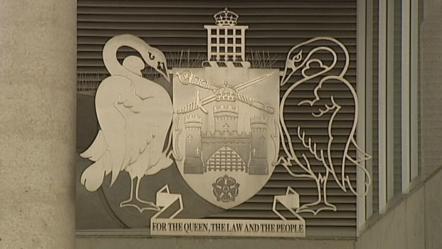 The ACT coat of arms features a castle, swords, crowns, two swans and the motto 'for the King, the law and the people'.