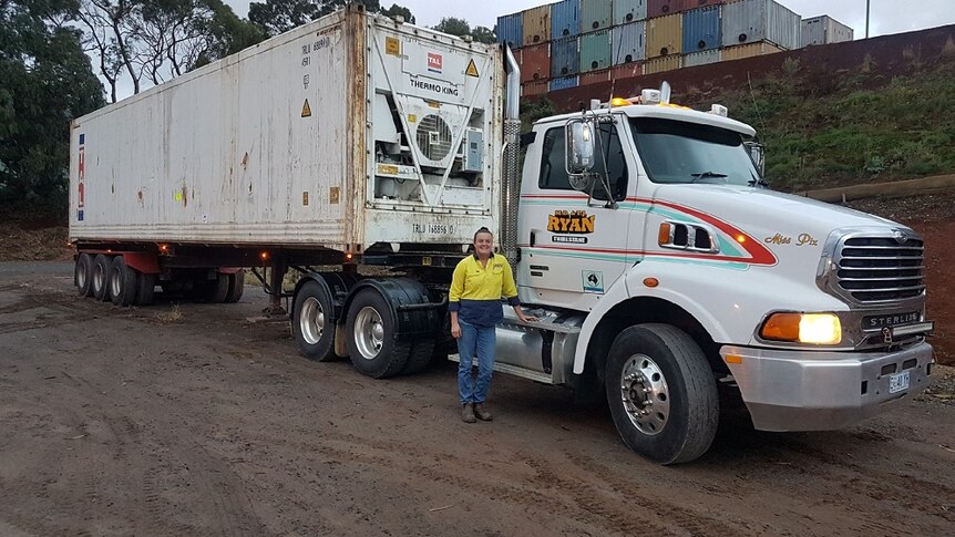 Truck driver Sarah Brosnan stands beside her semi trailer