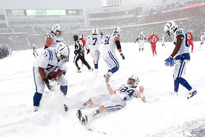 The Colts' Jack Doyle celebrates in the snowy end zone