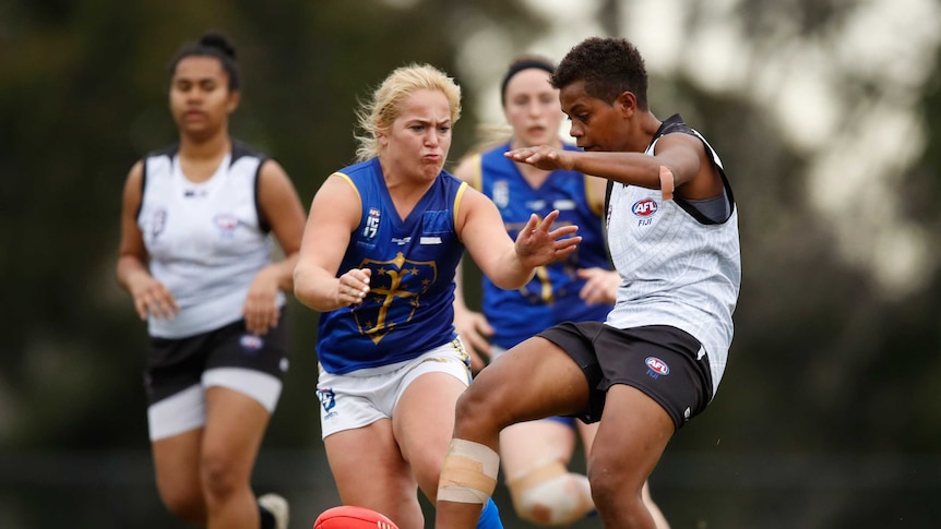 A player for the European Crusaders goes to tackle a Fijian player during the 2017 Women's International AFL Cup.