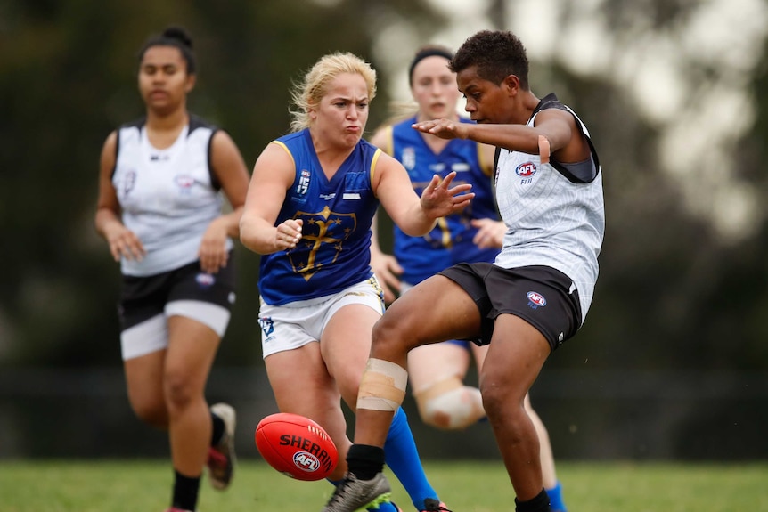A player for the European Crusaders goes to tackle a Fijian player during the 2017 Women's International AFL Cup.