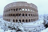 The Colosseum blanketed in heavy snow.