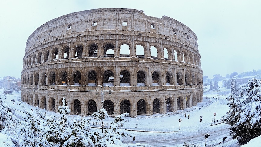 The Colosseum blanketed in heavy snow.