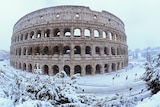 The Colosseum blanketed in heavy snow.