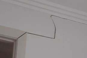 A wide crack in the interior wall of a home