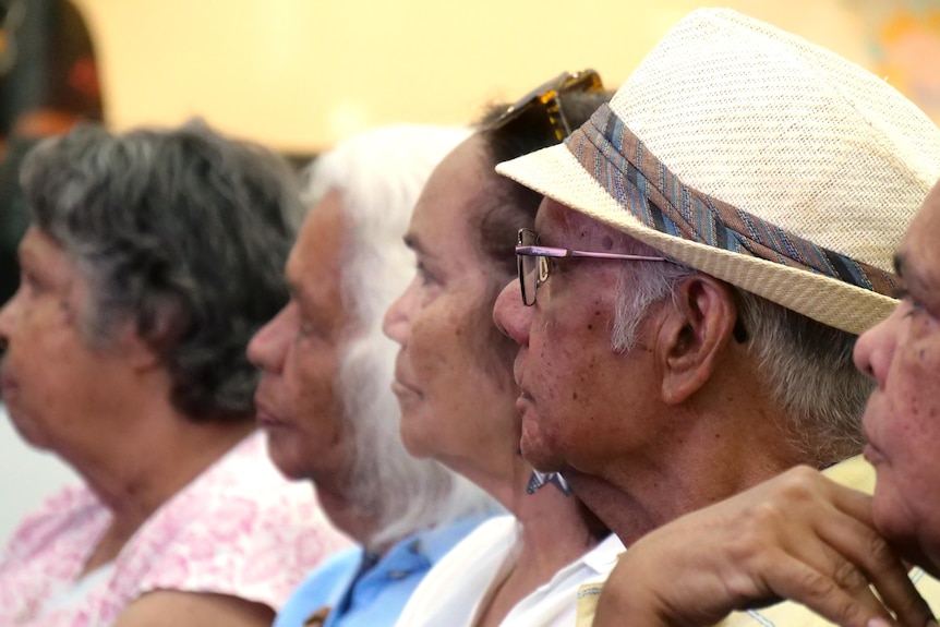 A number of elderly Indigenous people sitting in a row
