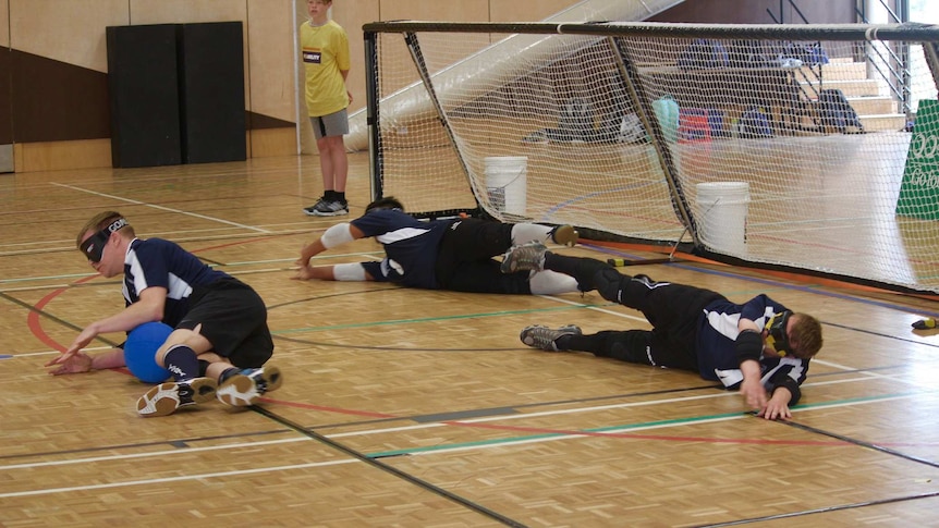 Goalball players defending a play