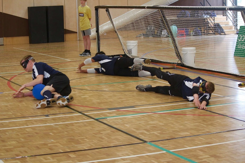 Goalball players defending a play