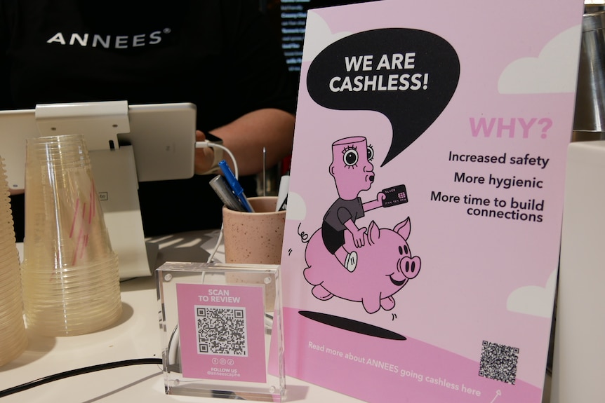 Sign on counter of coffee bar saying 'We are going cashless'. 