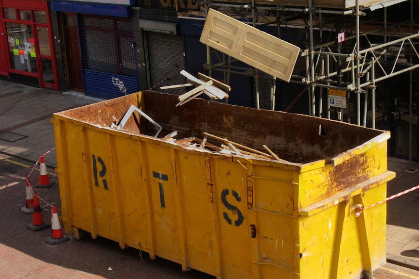 Building waste goes into a skip bin