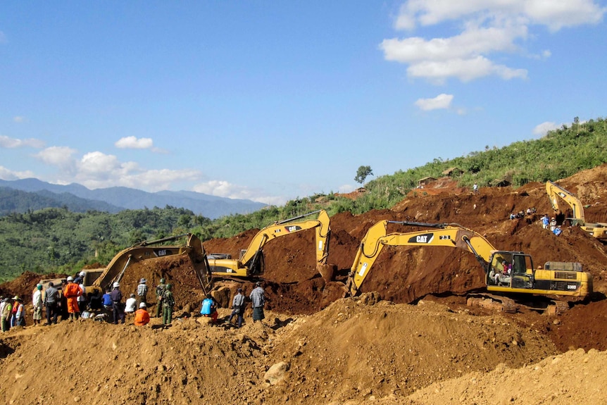 Rescue teams search for the bodies of miners in the landslide.