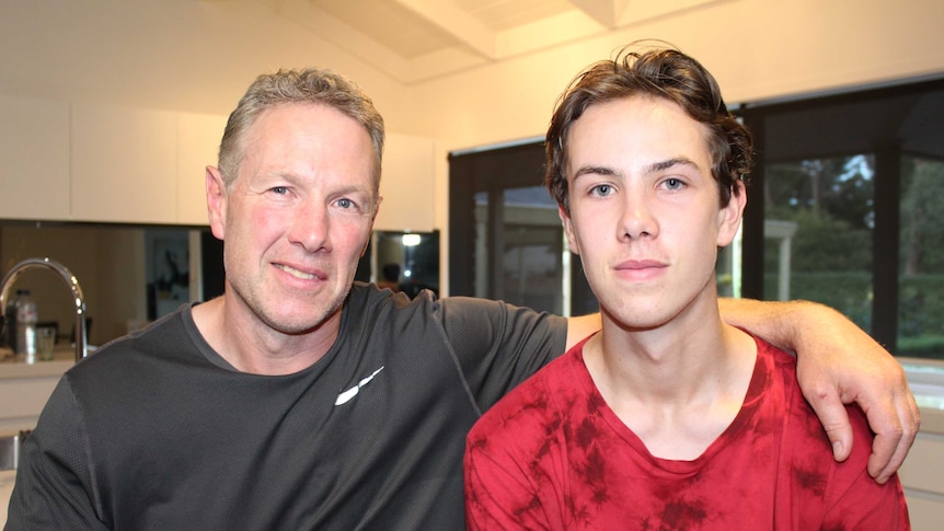 Former Collingwood player Gavin Brown with his arm around son Tyler Brown.