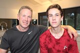 Former Collingwood player Gavin Brown with his arm around son Tyler Brown.