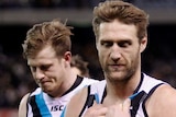 Dejected Port Adelaide players leave the field