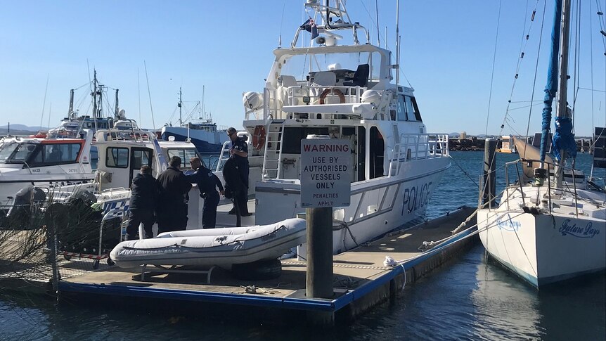 A group of police divers get ready to search the water