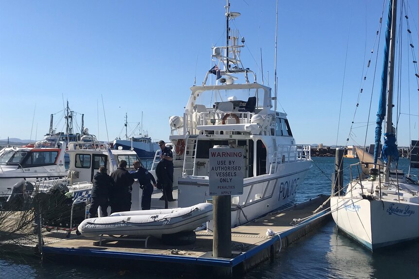 A group of police divers get ready to search the water