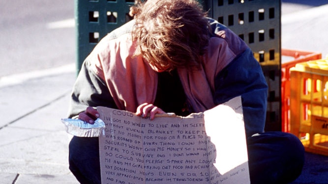 A homeless youth begs for money on the Southbank Boulevard, Melbourne.