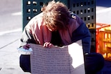 A homeless youth begs for money on the Southbank Boulevard, Melbourne.