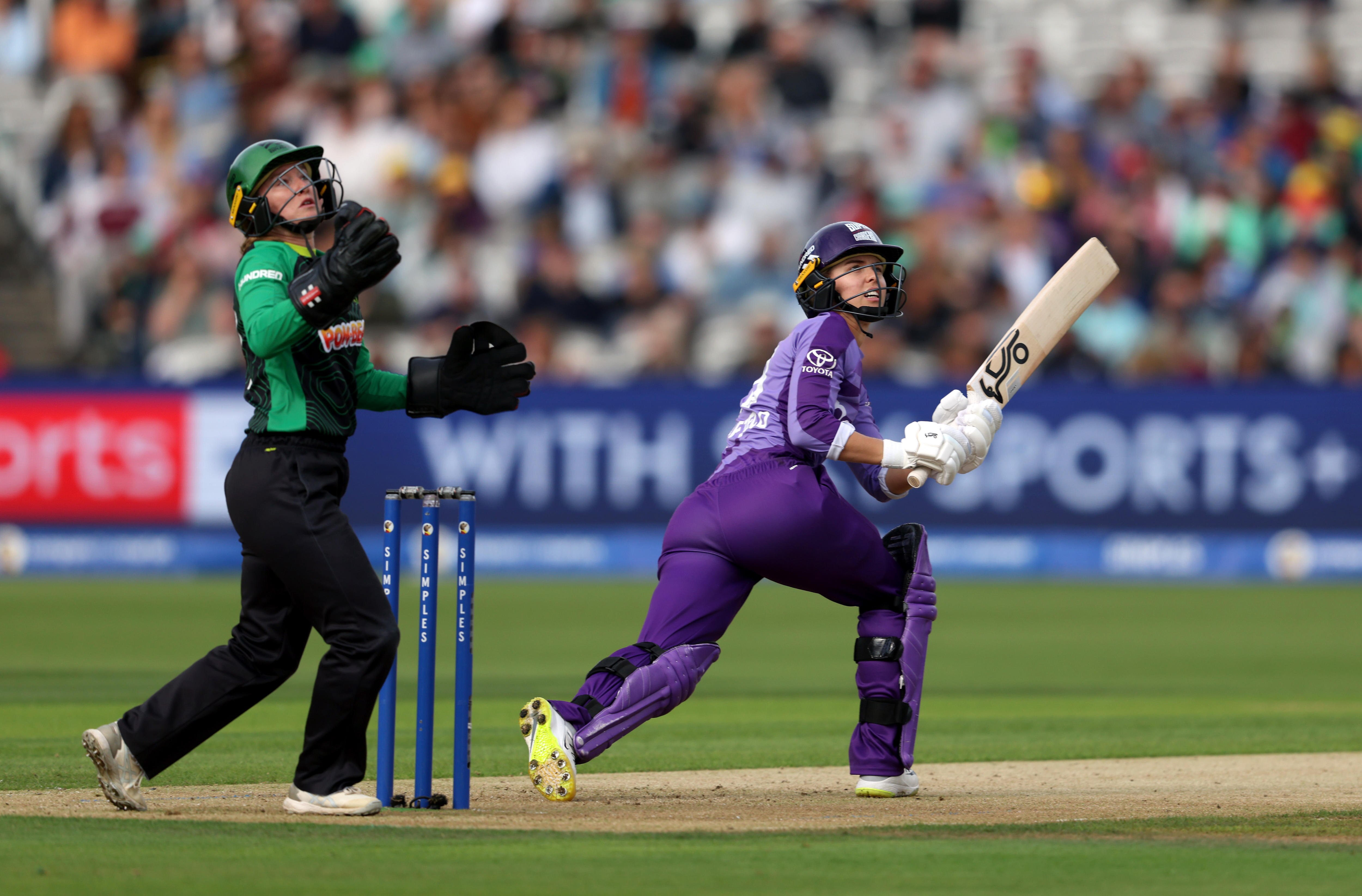 Phoebe Litchfield plays a shot as the wicketkeeper watches