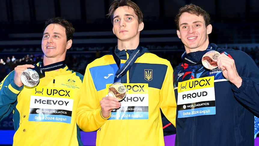 Cameron McEvoy has his silver medal as he stands alongside Vladyslav Bukhov and Benjamin Proud