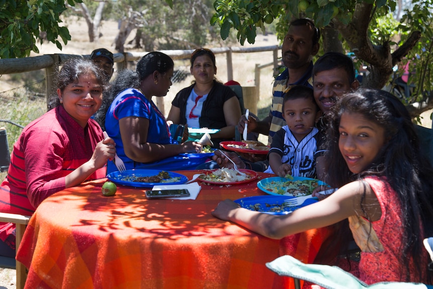 Asylum seeker families eat together