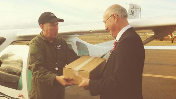 French Consul Eric Berti receives airmail at Bankstown Airport after the re-enactment of original flight 100 years ago.