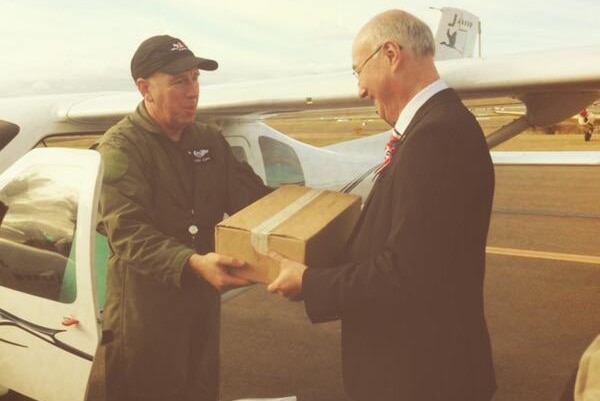 French Consul Eric Berti receives airmail at Bankstown Airport after the re-enactment of original flight 100 years ago.