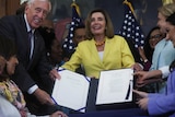  House members hold a signed copy of the "Inflation Reduction Act of 2022," at an enrollment ceremony 