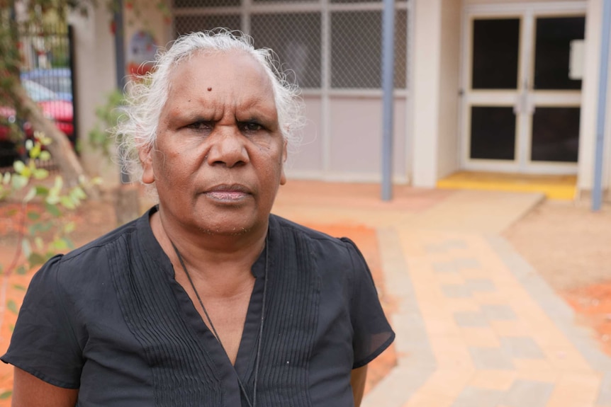 An Aboriginal woman stares down the camera.