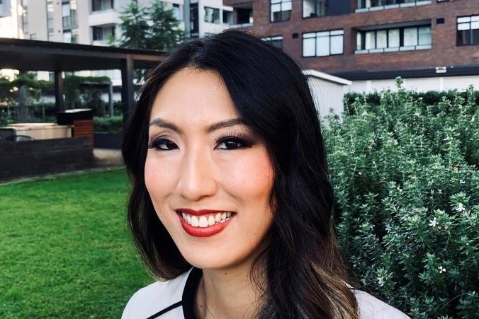 A woman with black hair smiling