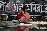 Indian social activists light candles during a protest in Kolkata