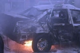 Burnt out shell of car after bomb blast in Iraq