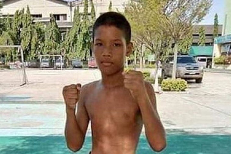 A shirtless, bare-fisted boy is seen in a boxing pose