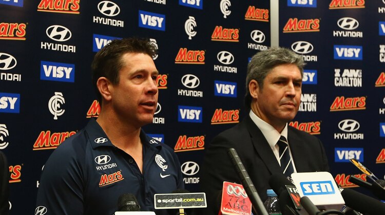 Carlton's Stephen Kernahan (R) listens as Brett Ratten gives his final press conference as coach.