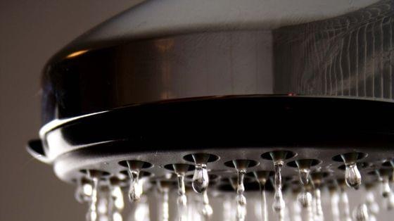 Water pours out of a shower head