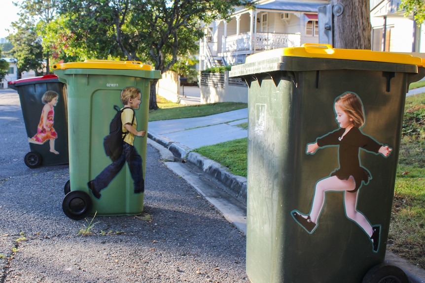 Life-sized stickers on wheelie bins are set to remind motorists to slow down.