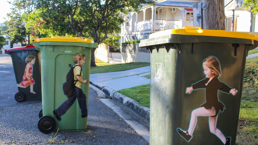 Life-sized stickers on wheelie bins are set to remind motorists to slow down.