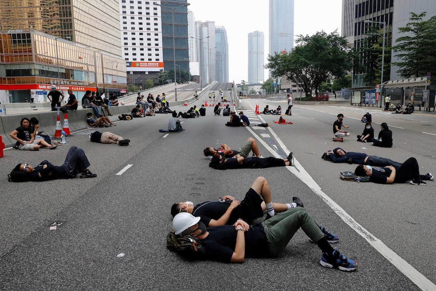 People lay on the street in the urban area of Hong Kong