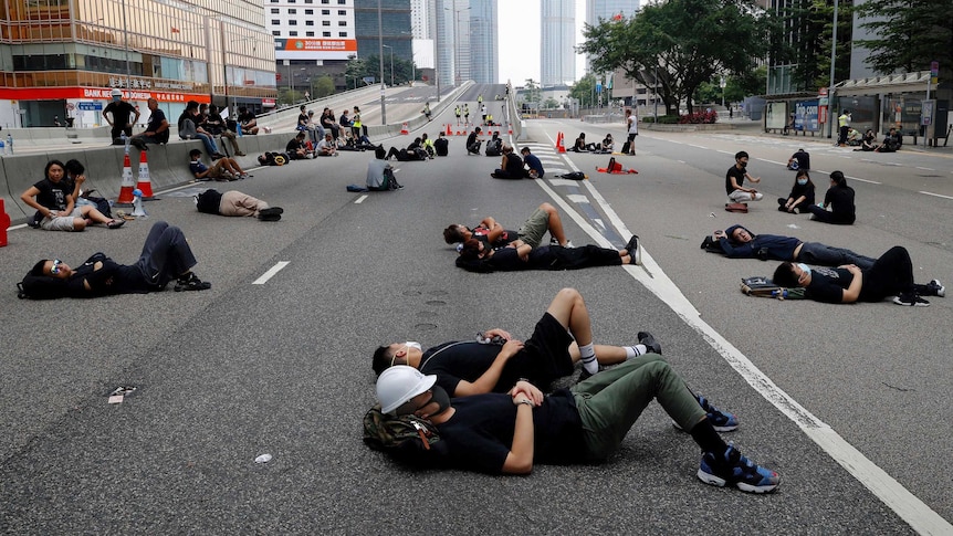 People lay on the street in the urban area of Hong Kong