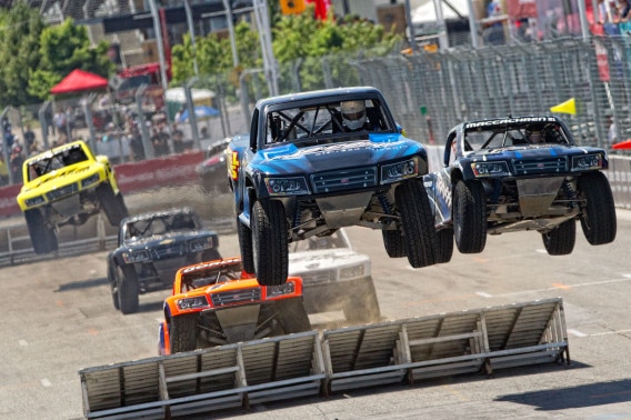 Stadium Super Trucks doing jumps on the track